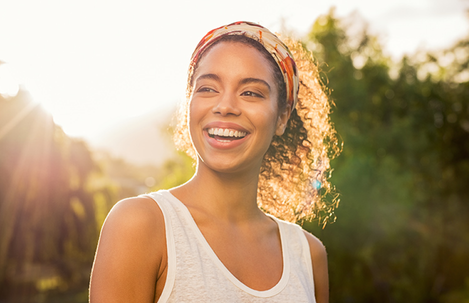 Woman outside enjoying the sun and showing happy expressions